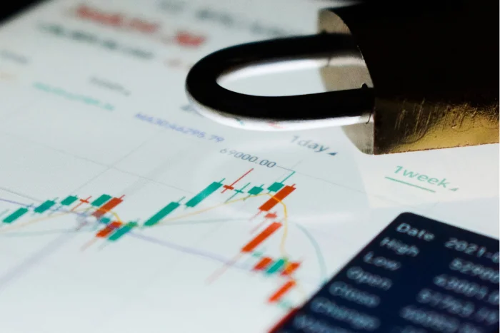 a lock on a screen showing financial charts